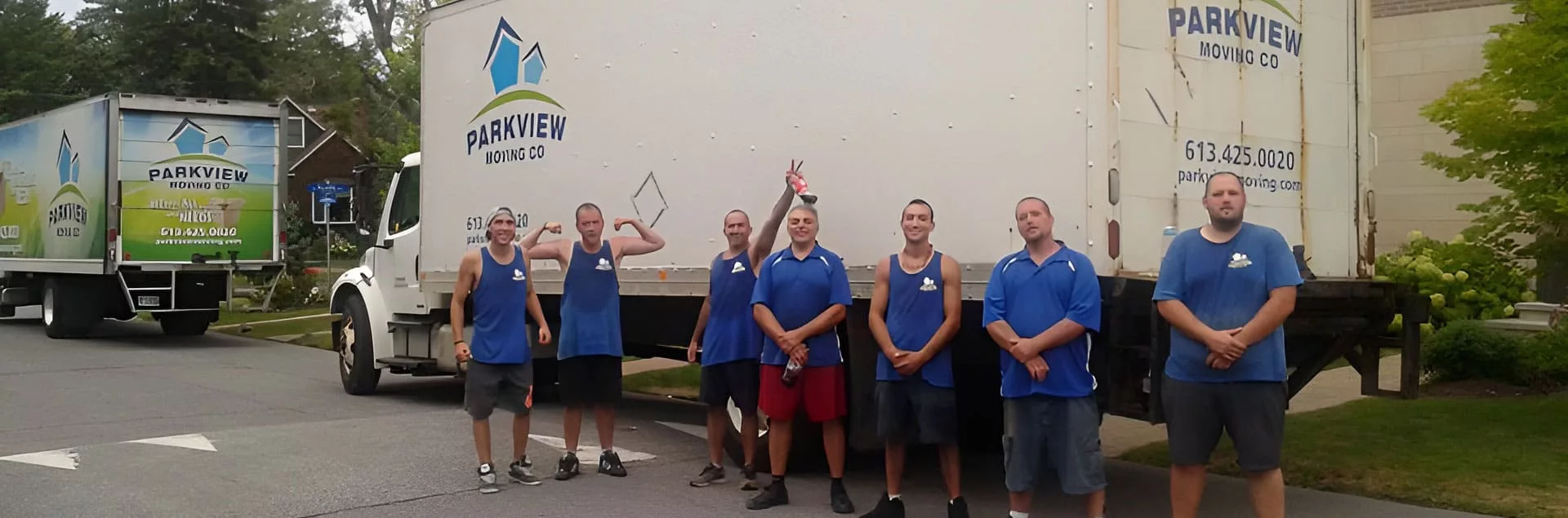 A group of movers about to board a moving truck.