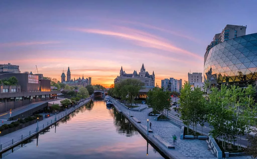 A sunset cityscape with a canal in dowtown Ottawa.