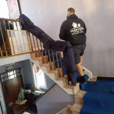 Movers protecting stairs during a move.