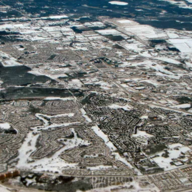 An aerial view of a city with snow on the ground.  Located in Kanata.