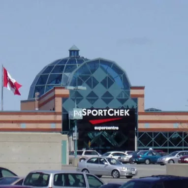 A large building with a Canadian flag waving proudly above it, visible to Orleans Movers.