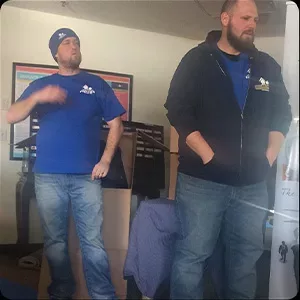 Two men in blue shirts standing in a room, one of whom is gesturing with his arm, appear in one of the photos.