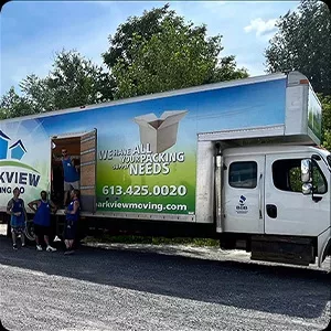 Photography of moving company employees standing by their truck, ready for service.