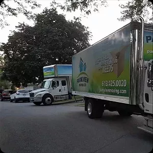 A moving truck from a company called "protein" is parked on a residential street, ready for its close-up in the photo gallery.