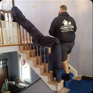A worker from a company called Parkview is on the stairs, likely performing some type of photography service in a home.