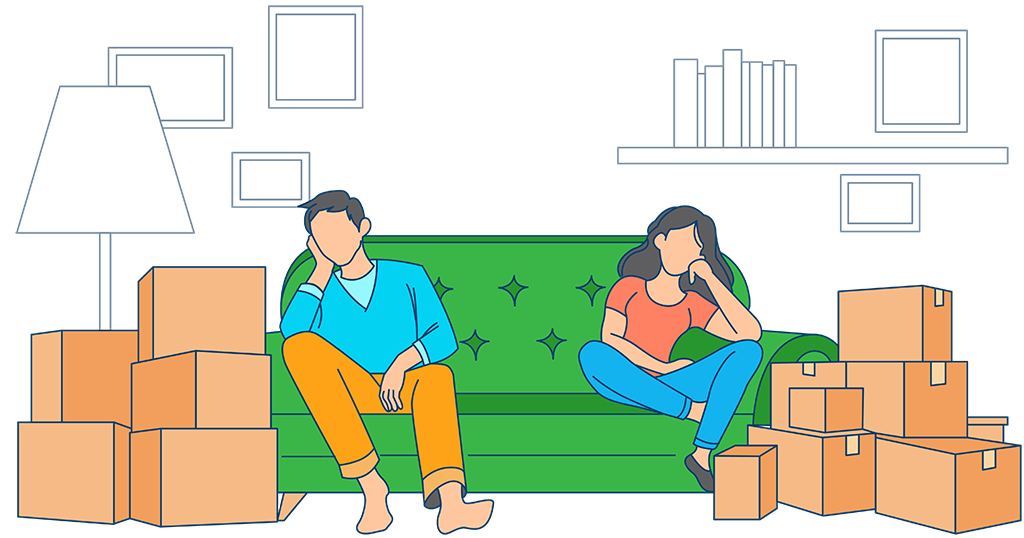 Couple sitting on couch surrounded by moving boxes after moving day.