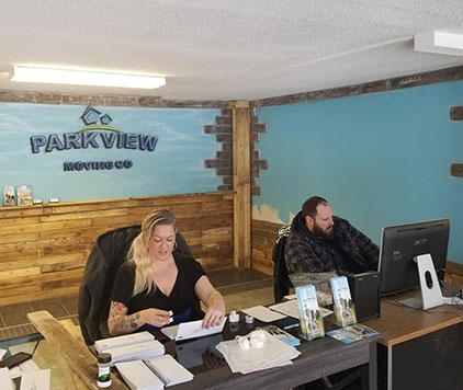 Amanda and Shaw working the phones at Parkview Moving’s office, providing excellent customer service and logistics support.