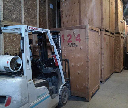 Forklift parked beside stacked wooden crates in Parkview Moving’s secure long-term storage warehouse in Ottawa.