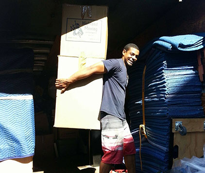 Parkview Moving Co. mover carefully carrying a moving box, showcasing professional and reliable moving services.