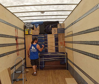 Parkview Moving Co. team member proudly standing by a perfectly packed moving truck, showcasing expert packing skills.