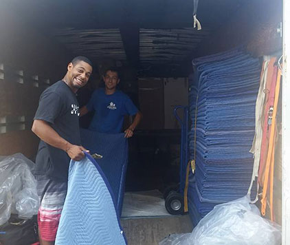 The Parkview Moving Co. team packing the truck and folding protective blankets after completing a successful long-distance move.