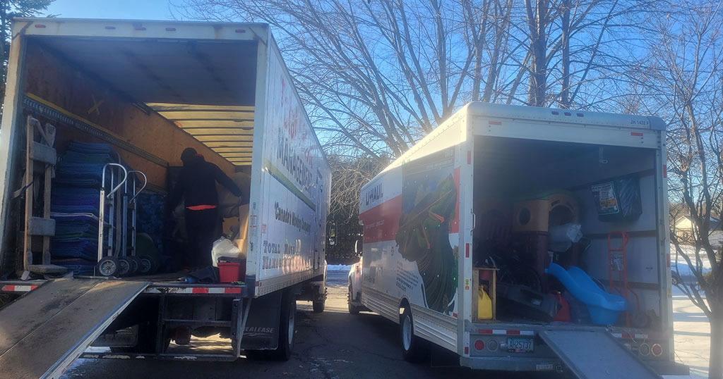 Comparison between a U-Haul rental truck and a professional long-distance moving truck, showcasing size and capability differences.