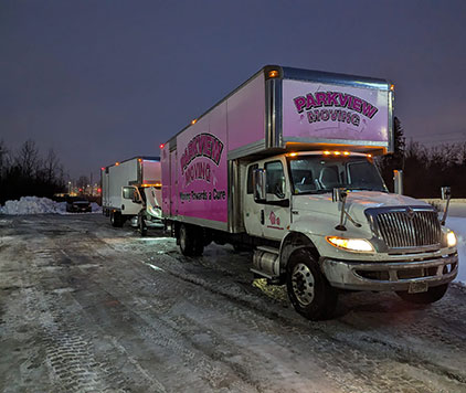 Long-distance moving in winter with Parkview Moving Co., showcasing safety precautions and truck maintenance during a stop.