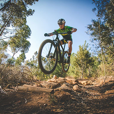 Cyclist riding a rocky trail on a mountain bike in Kanata.