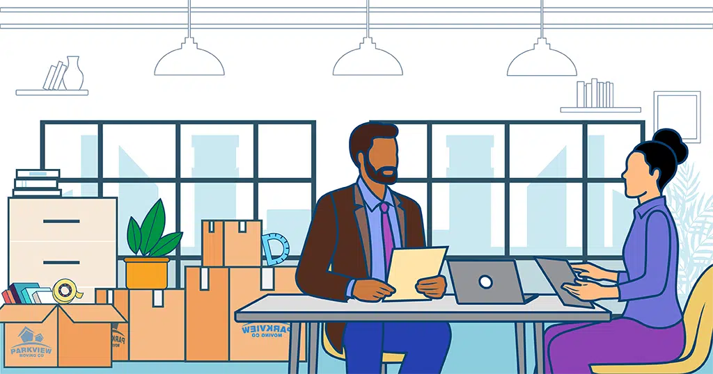 Employees preparing for an office move with packed boxes, following essential office relocation tips.
