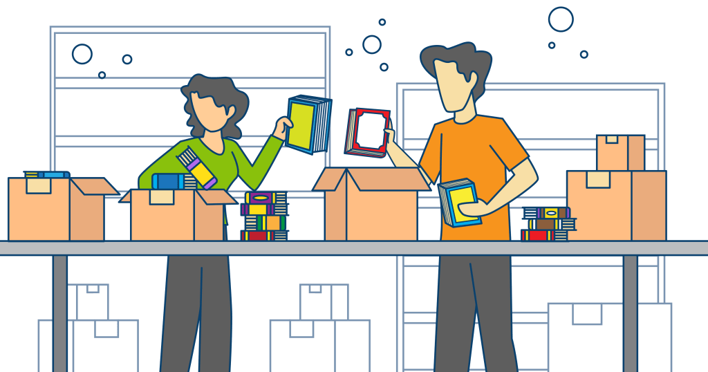 Two people diligently pack books into proper boxes in preparation for their upcoming move.
