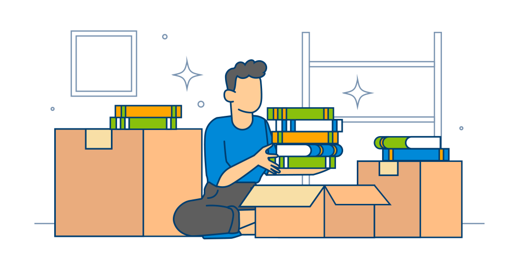 A person kneels beside cardboard boxes, sorting, stacking, and packing books in preparation for a move.
